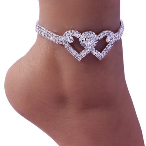 Diamond heart anklet on a foot.
