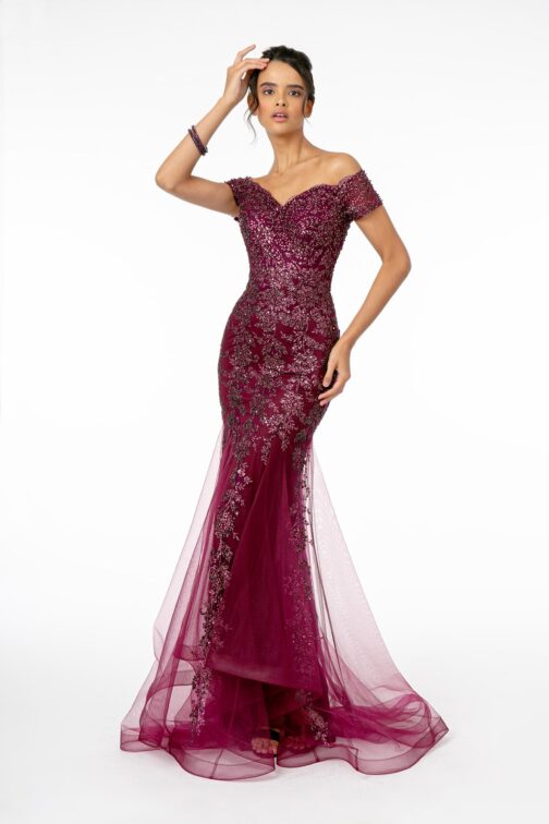 Woman in elegant burgundy evening gown.