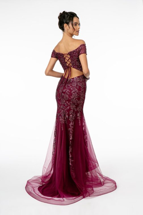 Woman in elegant burgundy lace evening gown