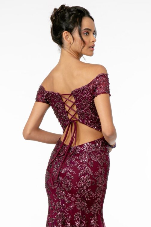 Woman in elegant burgundy sequined evening gown