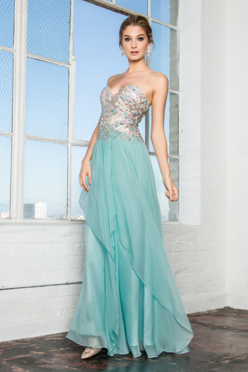 Woman in elegant teal evening gown with sequins.